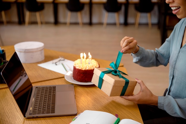 Close-up of a hand holding a wrapped gift box, symbolizing giving and care today.