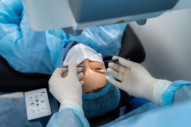 Close-up of a patient undergoing eye surgery with medical tools and surgeon’s hands in view.